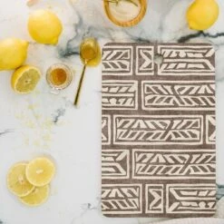 Little Arrow Design Co Rayleigh Feathers Brown Cutting Board - Deny Designs